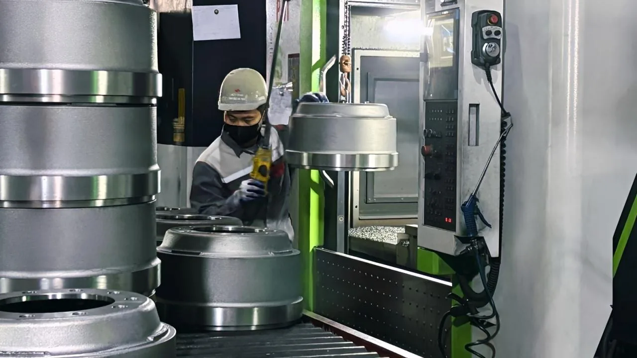 Machining line at the TBP Auto brake drum factory in Vietnam — finished drums coming off the production run