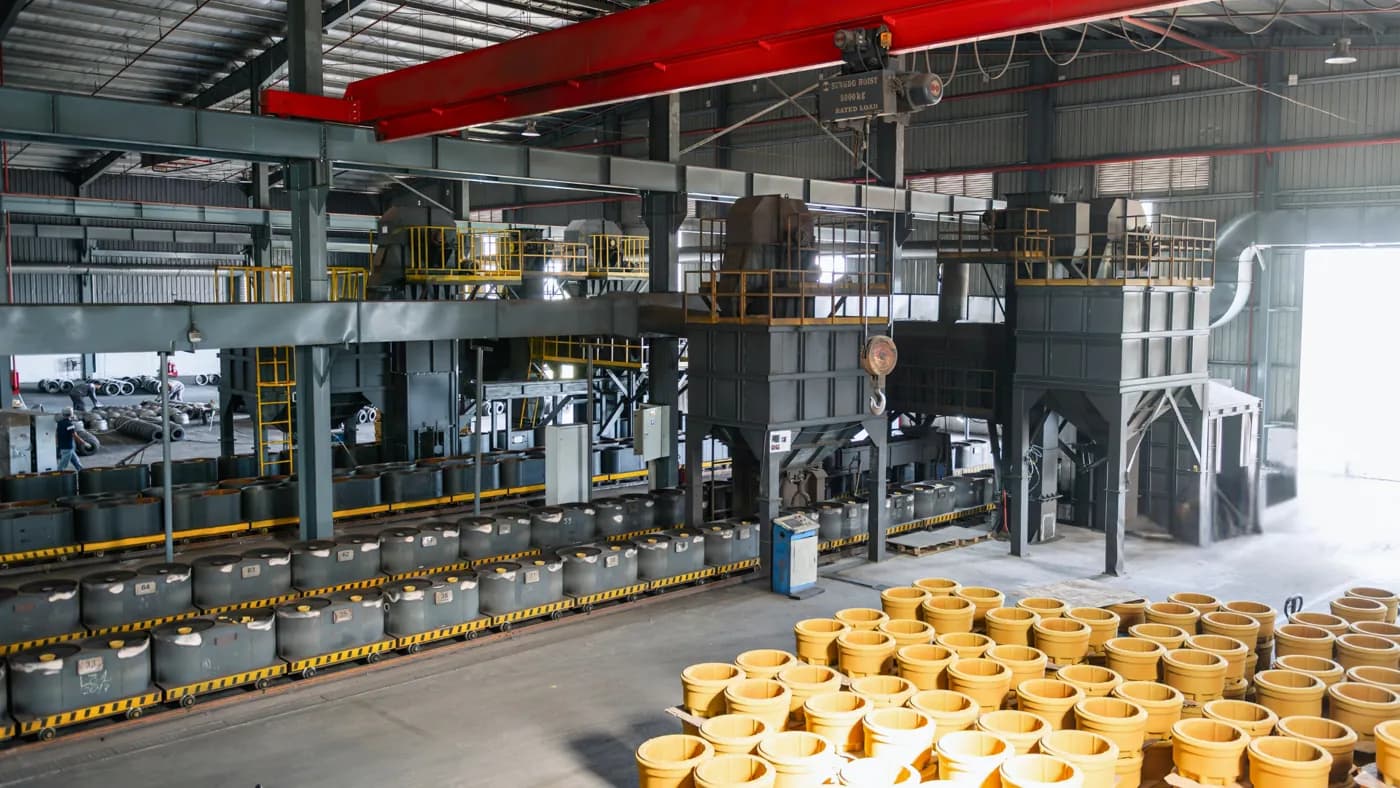Shot blast and cleaning hall on the new line, with cleaned brake drum castings staged in front of the machine