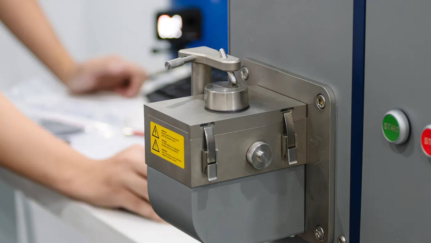 Operator loading a prepared sample onto the OE720 spark stand