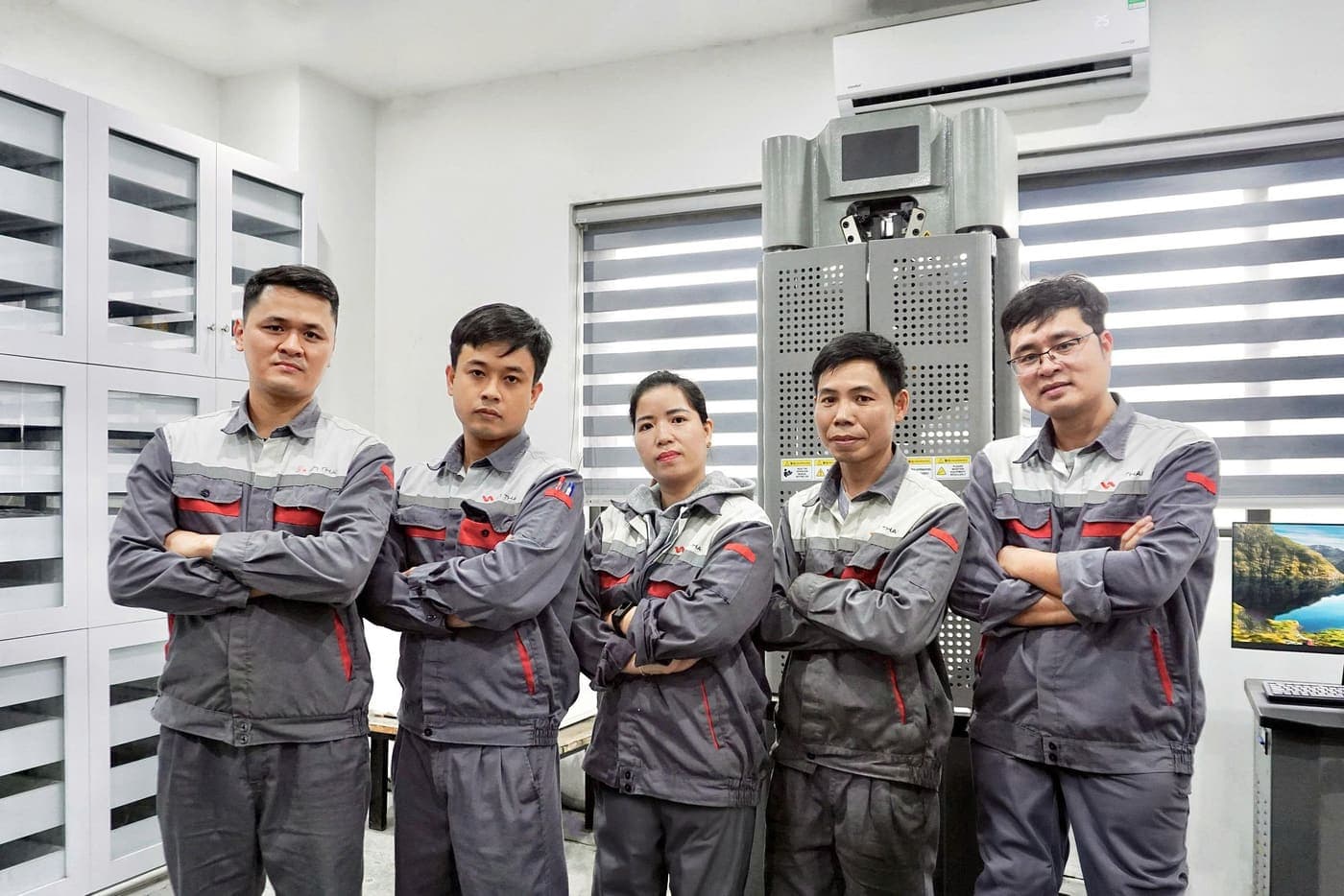 Engineering and lab team beside the test equipment, Hung Yen